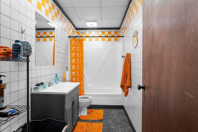 full bathroom featuring vanity, tile walls, shower / tub combo, and toilet