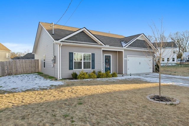 view of front of property featuring a front yard and a garage