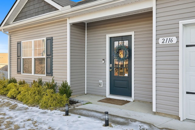 view of snow covered property entrance