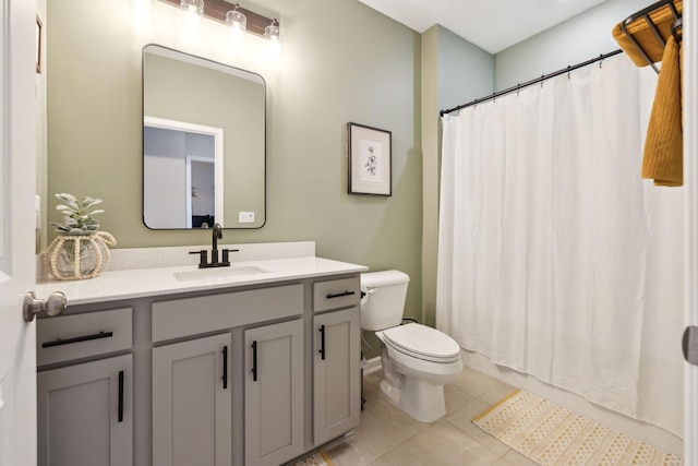 bathroom featuring a shower with shower curtain, tile patterned flooring, vanity, and toilet