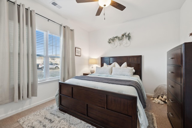 bedroom featuring ceiling fan and light carpet