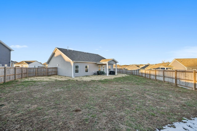 rear view of property with a lawn