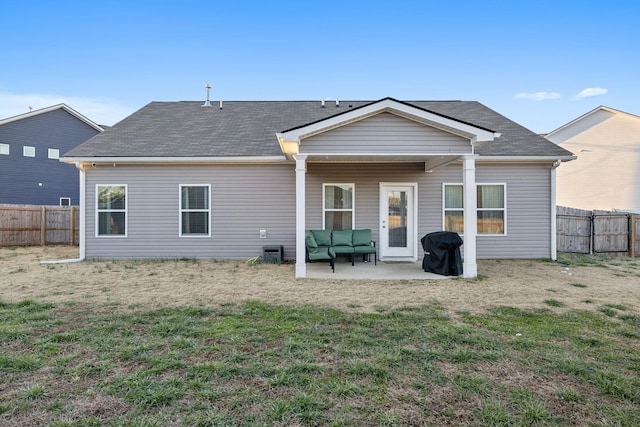 back of property featuring a lawn and a patio area