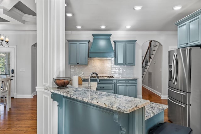 kitchen with custom range hood, a kitchen breakfast bar, stainless steel fridge with ice dispenser, and dark wood-type flooring