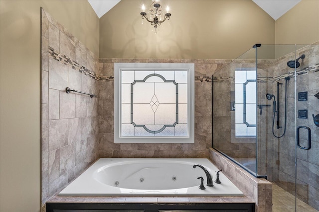 bathroom featuring a healthy amount of sunlight, vaulted ceiling, and shower with separate bathtub