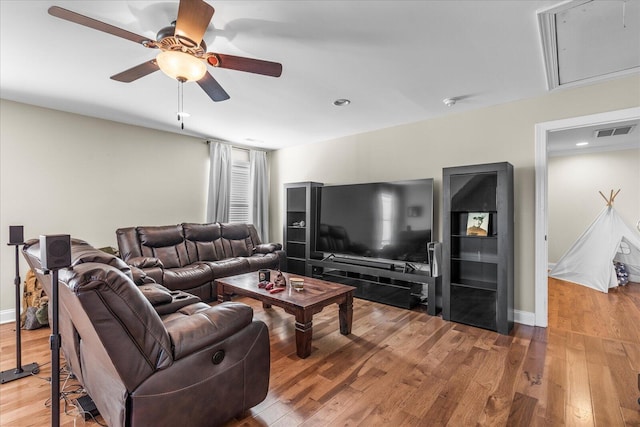 living room featuring ceiling fan and hardwood / wood-style flooring