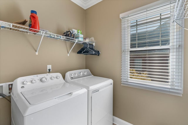 laundry room featuring ornamental molding and washer and clothes dryer