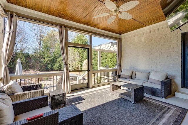 sunroom / solarium featuring ceiling fan, wood ceiling, and plenty of natural light