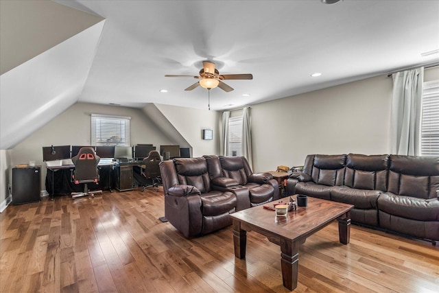 living room featuring vaulted ceiling, ceiling fan, and light hardwood / wood-style floors