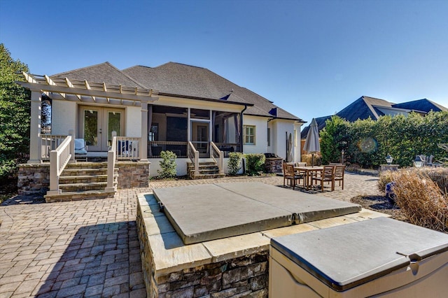 back of house with a patio, french doors, and a sunroom