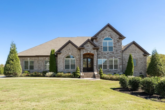 french country style house with a front lawn