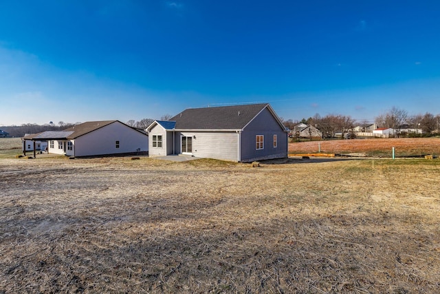 rear view of house featuring a lawn