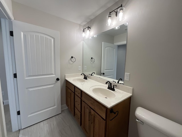 bathroom featuring toilet and vanity