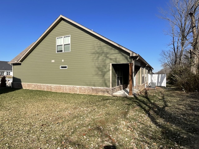 view of property exterior featuring central air condition unit and a yard