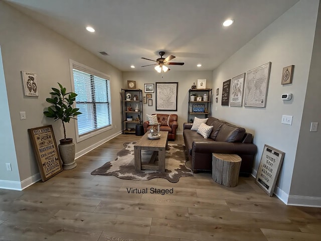 living room with ceiling fan and wood-type flooring