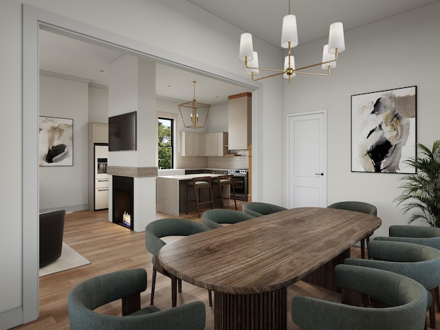 dining room featuring light wood-type flooring and a notable chandelier