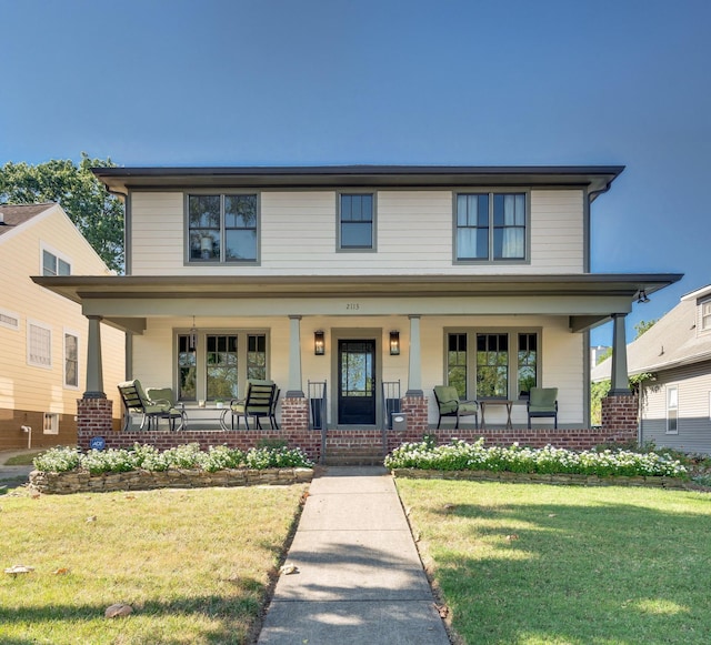 view of front of house with covered porch and a front yard