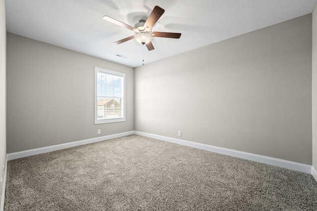 carpeted spare room with ceiling fan