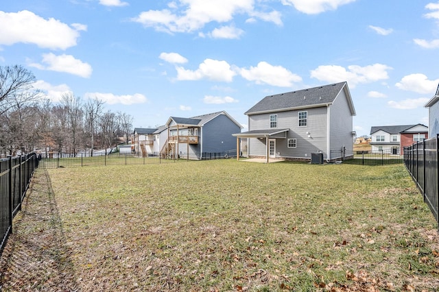 view of yard with central AC and a patio area