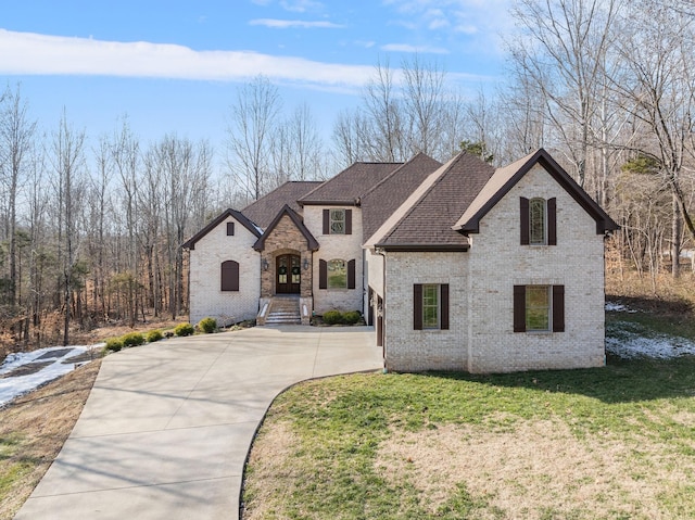 french country home with a front lawn