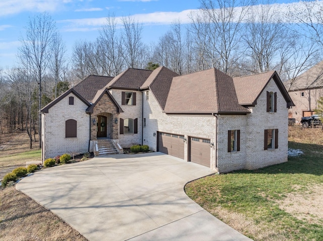 view of front of property with a front lawn and a garage