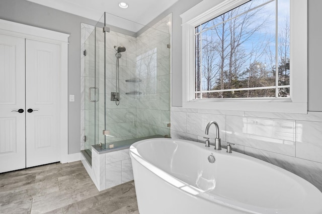 bathroom featuring shower with separate bathtub