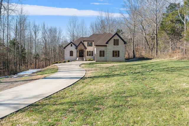 french provincial home featuring a front yard