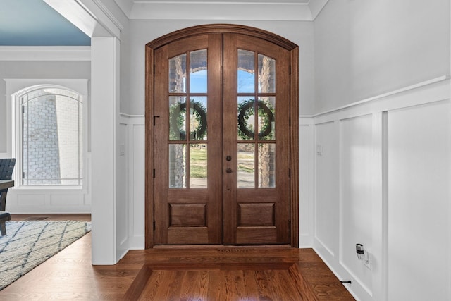 entryway featuring french doors, wood-type flooring, and ornamental molding