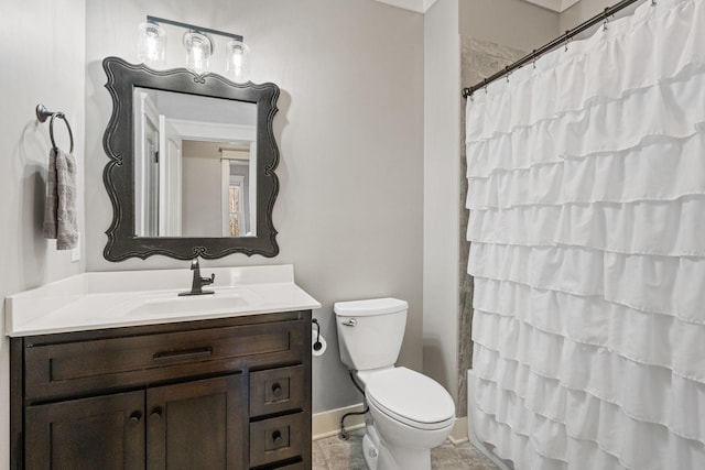 bathroom with curtained shower, vanity, and toilet