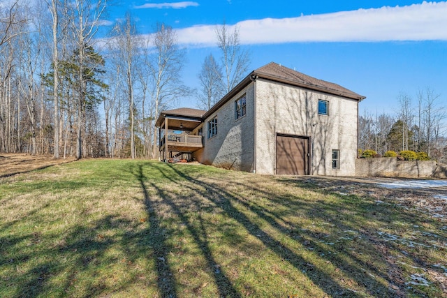 view of side of property with a lawn and a garage