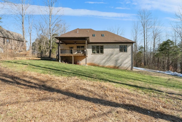 rear view of property featuring a yard