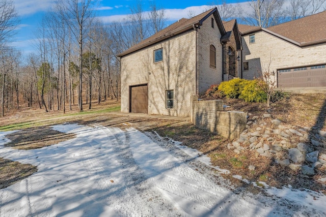 view of snowy exterior with a garage