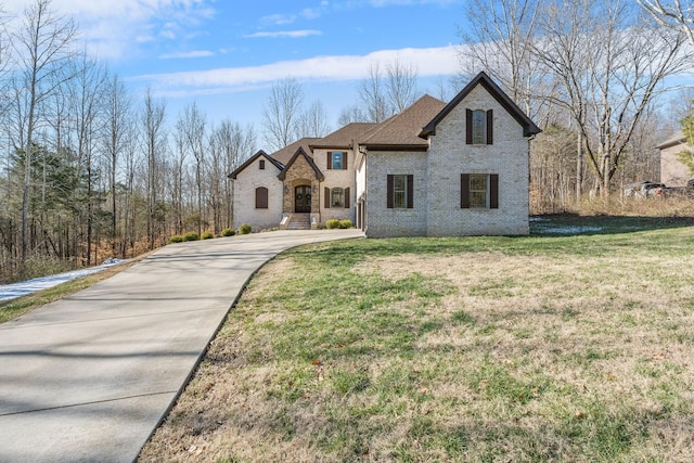 french country style house featuring a front lawn