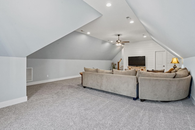 living room featuring ceiling fan, lofted ceiling, and carpet flooring