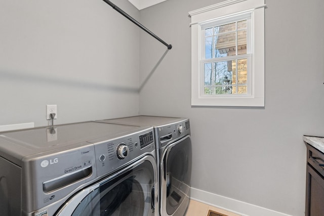 laundry area featuring washer and dryer and a healthy amount of sunlight