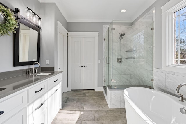 bathroom with plenty of natural light, plus walk in shower, crown molding, and vanity