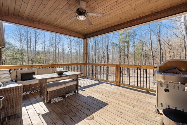 deck featuring ceiling fan and an outdoor living space