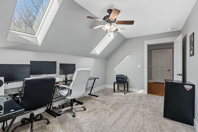 home office featuring ceiling fan, vaulted ceiling, and carpet