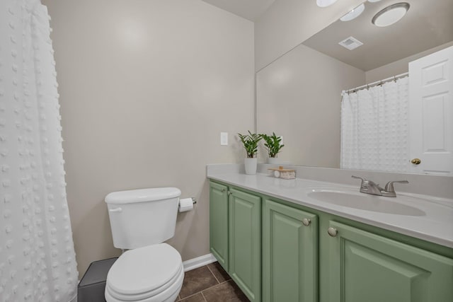 bathroom with vanity, tile patterned floors, and toilet