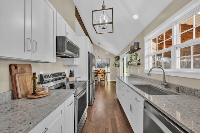 kitchen featuring appliances with stainless steel finishes, white cabinetry, hanging light fixtures, and sink