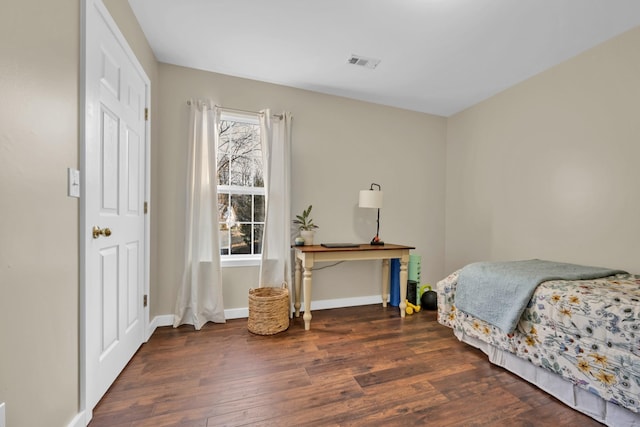 bedroom featuring dark wood-type flooring and multiple windows