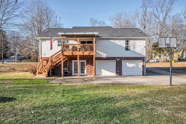 back of property featuring a patio area, a deck, a lawn, and a garage