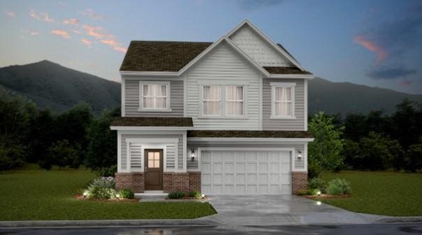 view of front of property with a mountain view, a yard, and a garage