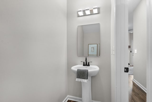 bathroom with hardwood / wood-style floors