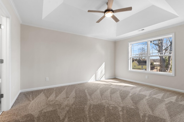 unfurnished room with ceiling fan, carpet, a tray ceiling, and ornamental molding