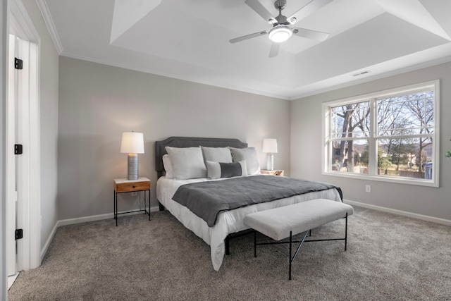 bedroom featuring a raised ceiling, ceiling fan, carpet, and ornamental molding