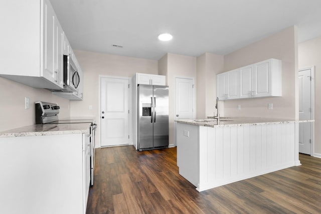 kitchen with light stone countertops, dark wood-type flooring, white cabinetry, stainless steel appliances, and sink