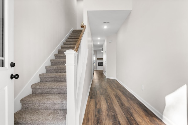 staircase with hardwood / wood-style flooring