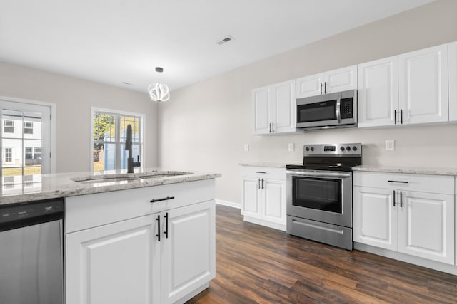 kitchen featuring sink, stainless steel appliances, white cabinets, dark hardwood / wood-style flooring, and light stone counters