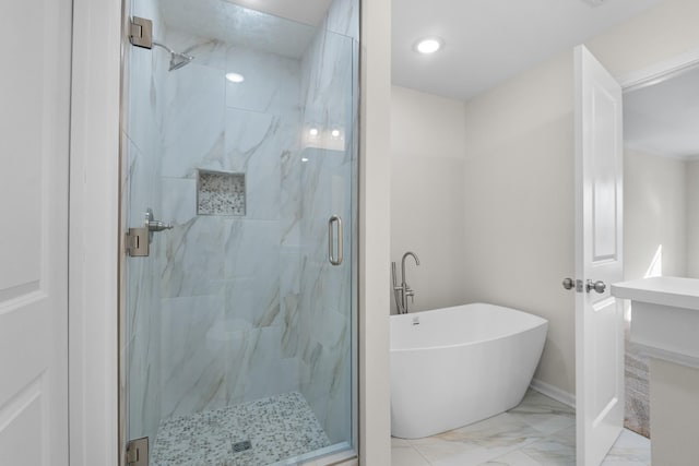 bathroom featuring separate shower and tub